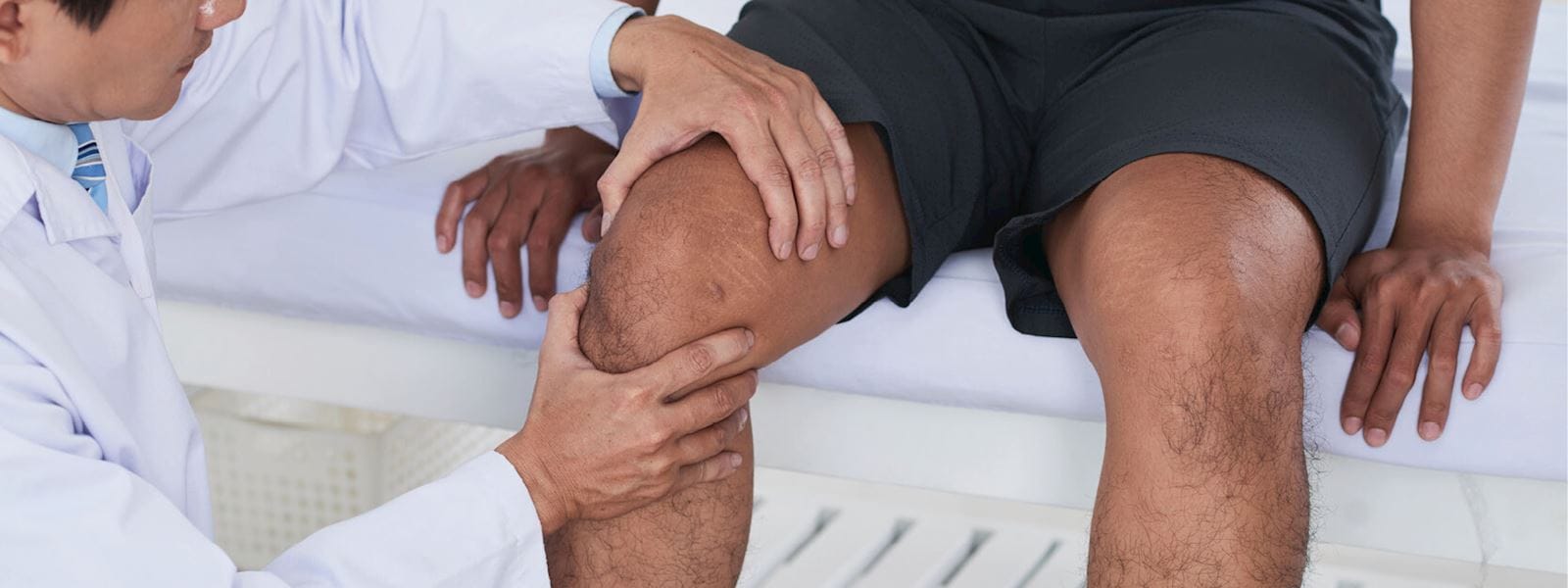 doctor examining a knee joint